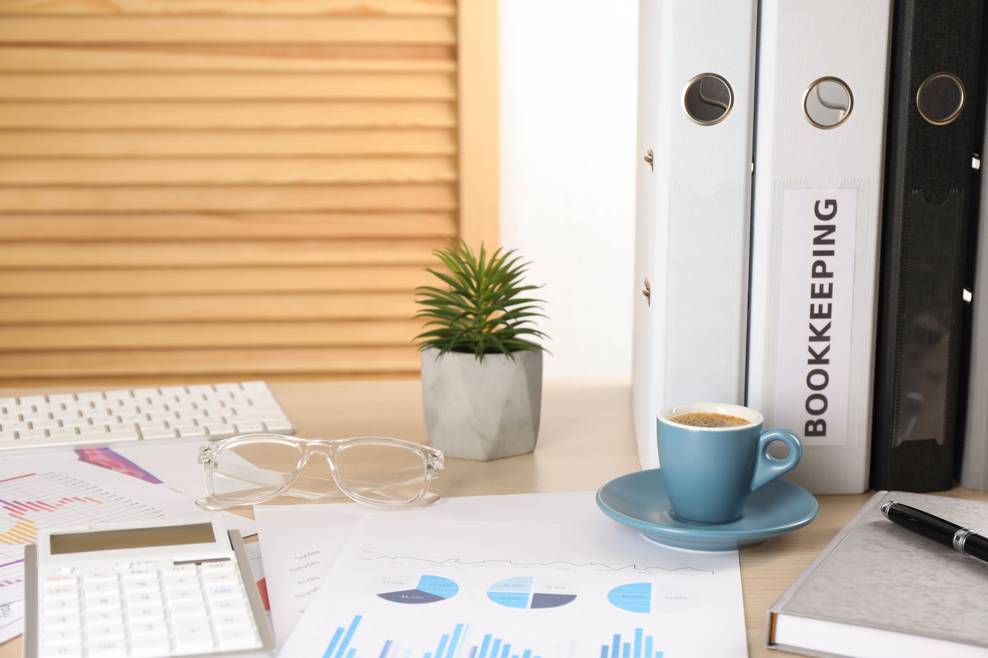 Bookkeeper's workplace with folders and documents on table