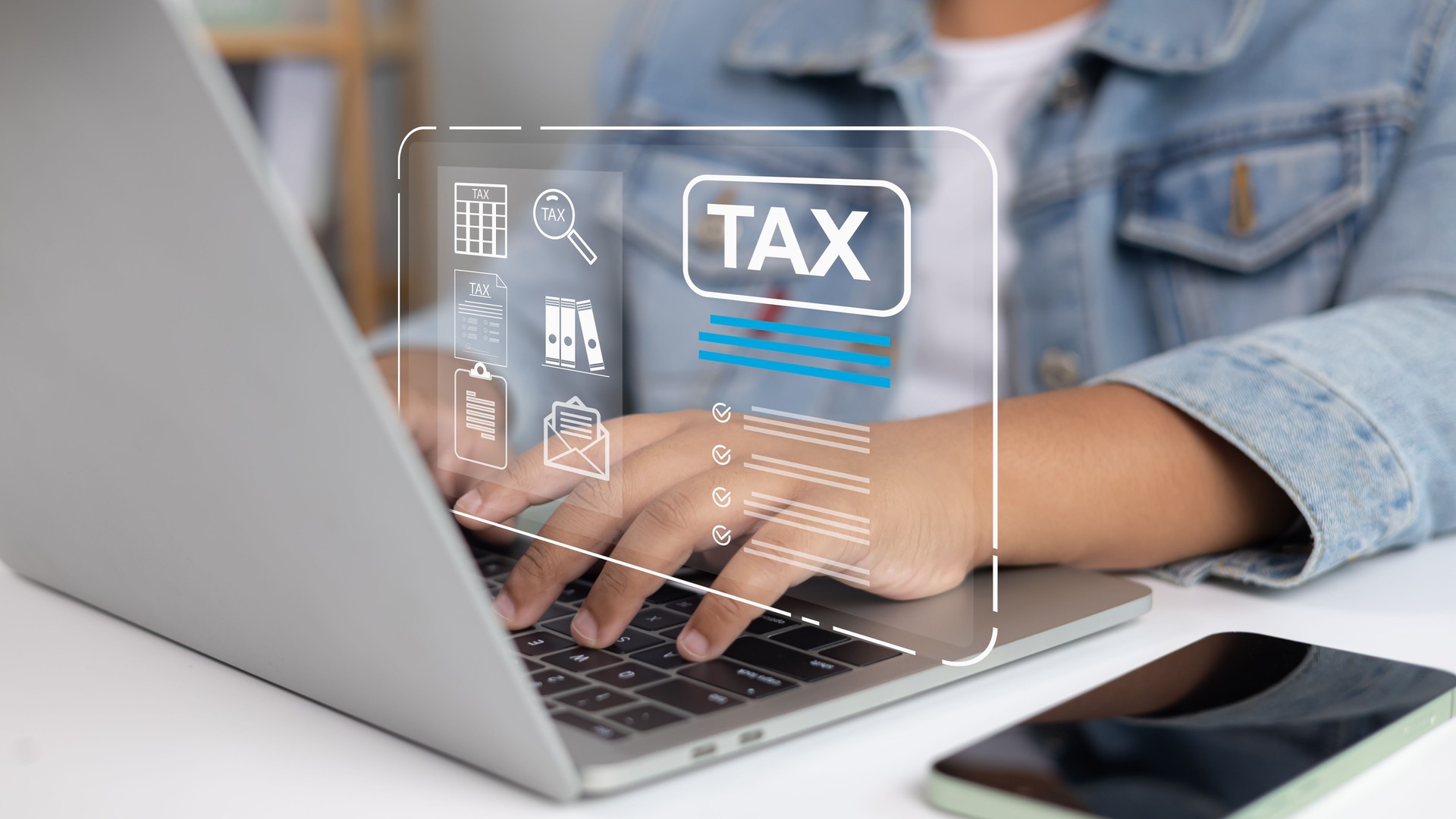 usinessman using laptop with tax icon overlay, online tax filing and digital financial planning concept